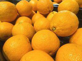 A stack of oranges displayed at the market or grocery store photo