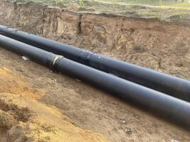 Pipes in the ground on the sand photo