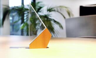 Business award made of glass and wood on a table with spotlights photo