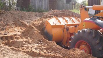 An excavator is smoothing sand at a busy construction site, showcasing its powerful machinery in action photo
