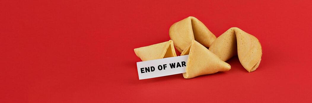Fortune Cookies with End of War Message on Red Background with Copy Space photo
