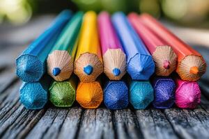 Close-up of Sharpened Color Pencils on Wooden Surface photo