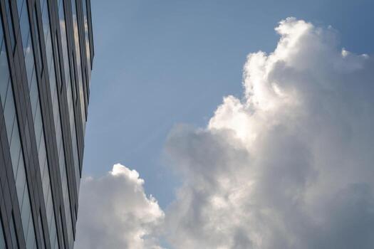 Clouds reflected on business building wall. Background image with copy space. photo