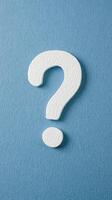 White Textured Question Mark on Blue Textured Background Highlighting Curiosity, Inquiry, and Communication for Conceptual Design in Education, Problem-Solving, Brainstorming, or Consultation photo