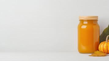 Homemade Pumpkin Jam in a Jar with Autumn Leaves and Pumpkin on Light Background for Seasonal Festive Design and Kitchen Decor photo