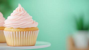 Freshly Baked Vanilla Cupcakes with Creamy Frosting on a Plate Against Mint Green Background for Bakery Confectionery Advertising or Celebration photo