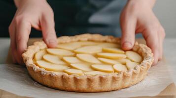 Hands Preparing Homemade Apple Pie with Fresh Slices Arranged Aesthetically on Crust in Bright Gourmet Kitchen Setting, Highlighting Culinary Artistry and Tradition in Modern Pastry Making photo