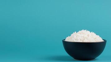 Freshly Steamed White Rice in Black Bowl on Turquoise Background Highlighting Minimalist Food Photography photo