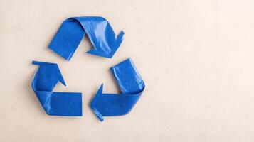 Blue Recycling Symbol On Neutral Background Emphasizing Environmental Awareness And Sustainability Efforts With A Minimalist Design Approach For Eco-Friendly Campaigns Highlighting Waste Reduction photo