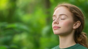 Tranquil Young Woman with Closed Eyes Breathing Deeply in Lush Green Forest Background for Relaxation Nature and Wellness Lifestyle Concept photo