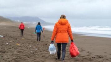 Ocean Conservation Volunteers Collecting Plastic Waste on Beach in Winter, Promoting Environmental Sustainability and Awareness, with Overcast Skies and Teamwork Focused on Coastal Cleanup photo