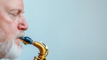 Close Up of Elderly Man Playing Saxophone with Focus on Instrument Details Against Soft Blue Background for Music Enthusiasts and Creative Professionals in Art and Music Industries photo