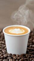 Steaming Cup of Coffee with Intricate Latte Art Surrounded by Freshly Roasted Coffee Beans in Warm Ambient Coffeehouse Setting Perfect for Cafes and Coffee Lovers During Cozy Winter Days photo