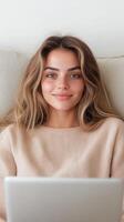 Smiling Woman Enjoying Digital Leisure Time With Laptop Indoors In Cozy Sweater And Relaxed Atmosphere photo