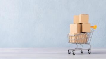 Shopping Cart with Cardboard Boxes on Laptop Keyboard Against Light Blue Background Reflecting E-commerce and Online Shopping Concepts photo