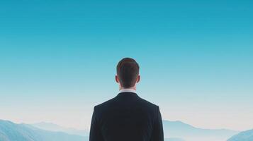 Businessman Looking Through a Telescope at the Starry Night Sky Symbolizing Future Vision and Aspirational Goals in a Serene Landscape with Clear Blue Skies photo