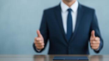 Confident Businessman Giving Thumbs Up Gesture in Suit at Office Desk with Digital Tablet photo