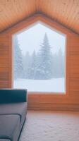 Cozy Cabin Interior With Snowfall View Through Hexagonal Window During Wintertime Creating Serene Atmosphere Featuring Wooden Walls Modern Couch And Snow Covered Evergreen Trees photo