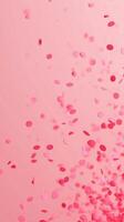 Pink Confetti Falling on Light Background in Vertical Frame for Party Celebration or New Year Festive Design photo