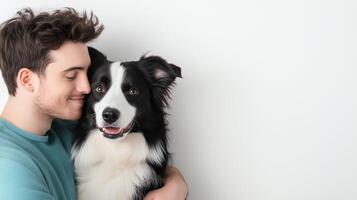Romantic Couple with Smiling Pet Dog on White Background, Young Man Hugging Adorable Border Collie, Happy Pet Owner, Minimalist Portrait of Friendship, Love and Loyalty in Simple Setting photo