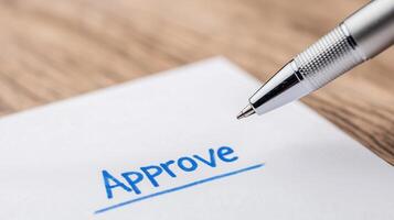Pen Writing Approve on White Paper Close Up with Wooden Background Highlighting Agreement Concept and Approval Process for Office Business Design and Documentation in Blue Ink photo