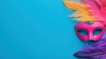 Vibrant Pink Carnival Mask and Colorful Feathers Arranged on Bright Blue Background for Festive Celebration Design photo