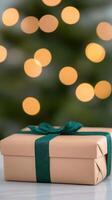 Elegant Christmas Gift Wrapped in Gold Paper with Green Ribbon, Holiday Present with Sparkling Bokeh Lights in Soft Focus, Festive Background Display for Seasonal Celebrations and Gift Ideas photo