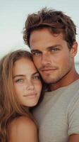 Close-up portrait of a young couple embracing outdoors with a soft blue background. Concept of love, affection, and connection for design and print photo