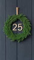 Elegant Black and Gold Advent Calendar With Festive Green Wreath and Number 25 on Dark Vertical Wooden Background for Christmas Holiday Decor photo
