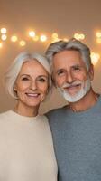 Smiling elderly couple posing together indoors with warm fairy lights in the background. Portrait concept of love, companionship, and happiness photo