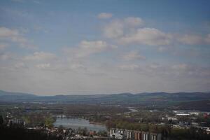 Trencin, Slovakia, March 10, 2024 Bird eye view photo of the famous Europe city in Slovakia with a tower and the old, ancient street in the center of the city. The river of Vah in the spring