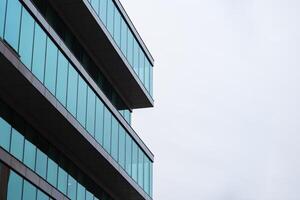 New blue glass building architecture on blue sky background,Low angle architectural exterior view of modern, copy space for text photo