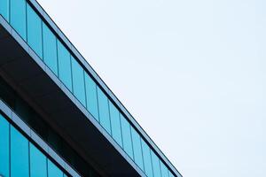 New blue glass building architecture on blue sky background,Low angle architectural exterior view of modern, copy space for text photo