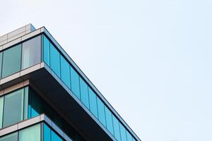 New blue glass building architecture on blue sky background,Low angle architectural exterior view of modern, copy space for text photo