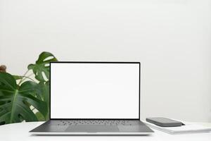 workspace with blank laptop computer with white screen for mockups, on white surface,Copy space photo