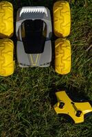 yellow jeep with remote control toy on green grass photo