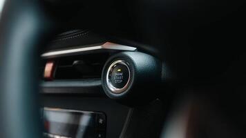Close-up of a car start button. Concept of modern technology, convenience, and innovation in cars. Dashboard with focus on engine start stop button, car interior details. Banner, free copy space photo