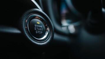 Close-up of modern car's engine start and stop button, offering convenience, keyless ignition. Press the button to start or stop the engine, a feature in many modern vehicles. Banner, ads, copy space photo