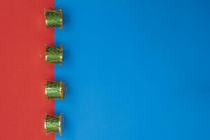 Festive green miniature drums on a vibrant red and blue background photo