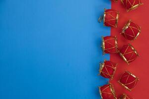 Festive red and gold miniature drums on a vibrant blue and red background photo