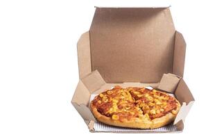 Delicious cheese and corn pizza in open cardboard box on a white background, closeup photo