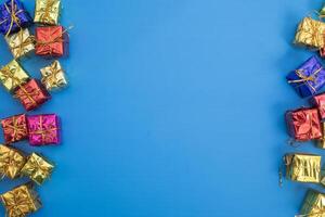 Colorful gift boxes on blue background with copy space photo