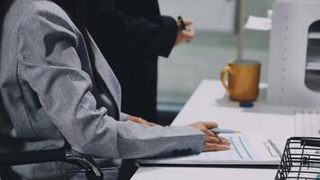 Two business leaders talk about charts, financial graphs showing results are analyzing and calculating planning strategies, business success building processes. video