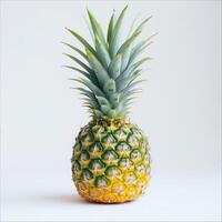 A ripe pineapple with a yellow crown on a white background. photo