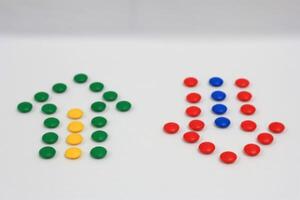 Up and down arrows created with colorful candy dots on a white background, representing direction, choice, and balance photo