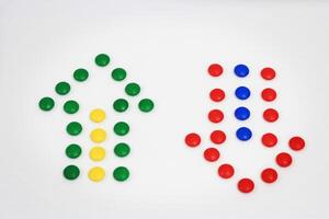 Up and down arrows created with colorful candy dots on a white background, representing direction, choice, and balance photo
