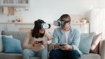 In a cozy living room, a young couple engages in a virtual reality gaming session, wearing headsets and holding game controllers while seated on a comfortable sofa. video