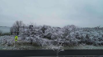 Aerial side view of road and frozen trees in Czechia in December 2024 video