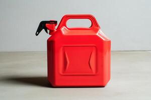 Modern red gasoline canister with spout and ergonomic molded handles photo