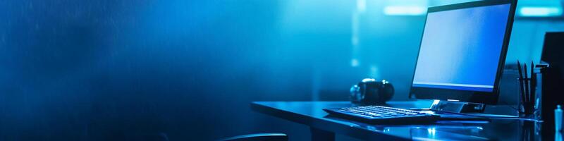 Wide-Angle Desk with Laptop on Dark Blue Background with Copy Space photo